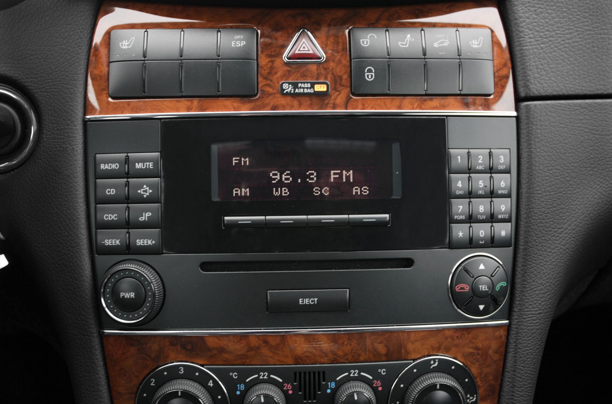 Center console radio and climate controls with wood trim and classic buttons