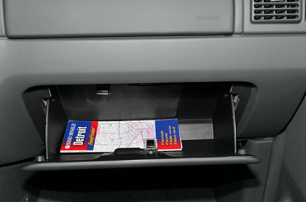 Open glove box with Rand McNally Detroit map inside