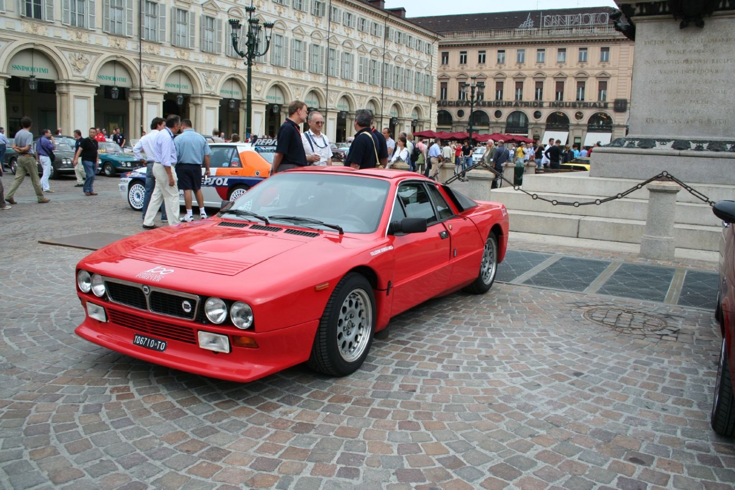 Red vintage sports coupe with quad round headlights and racing design