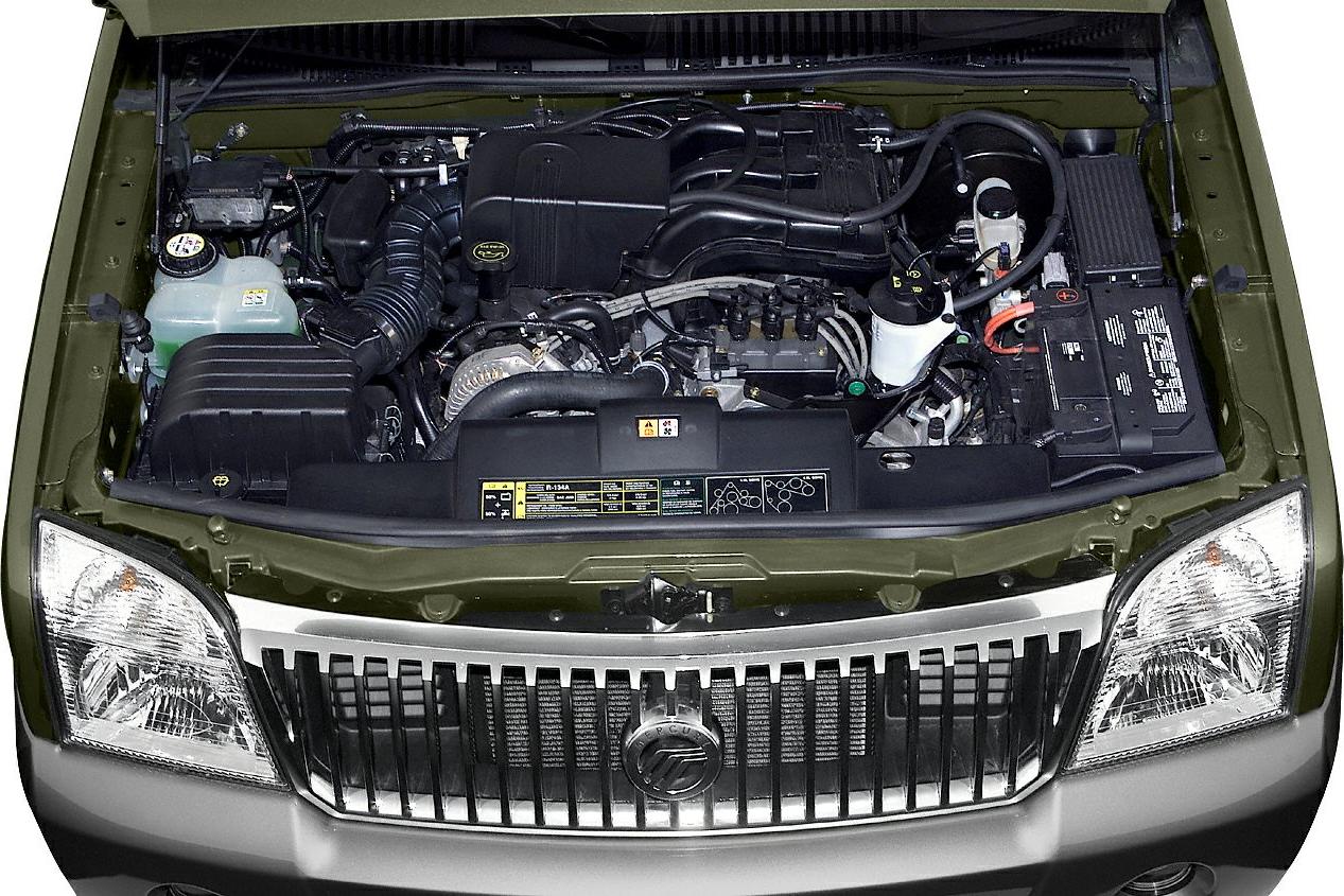 Engine bay with hoses, battery, and coolant reservoir
