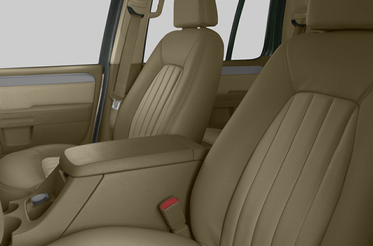 Tan leather front seats with center console in vehicle interior.