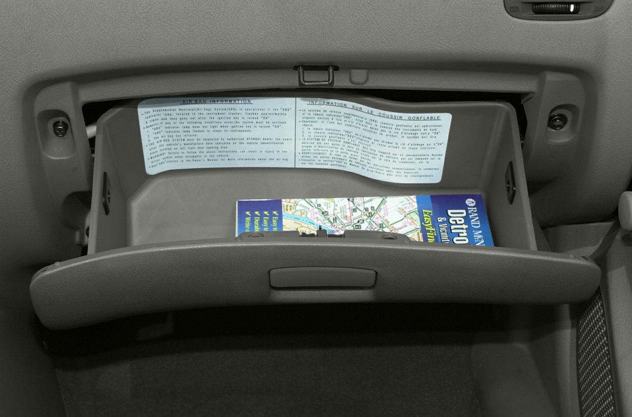 Open glove compartment with road map inside