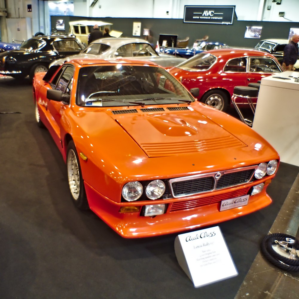 Orange vintage sports car with quad round headlights and aerodynamic shapes