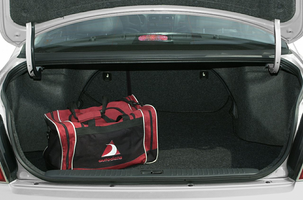 Spacious open car trunk with a red and black sports bag inside