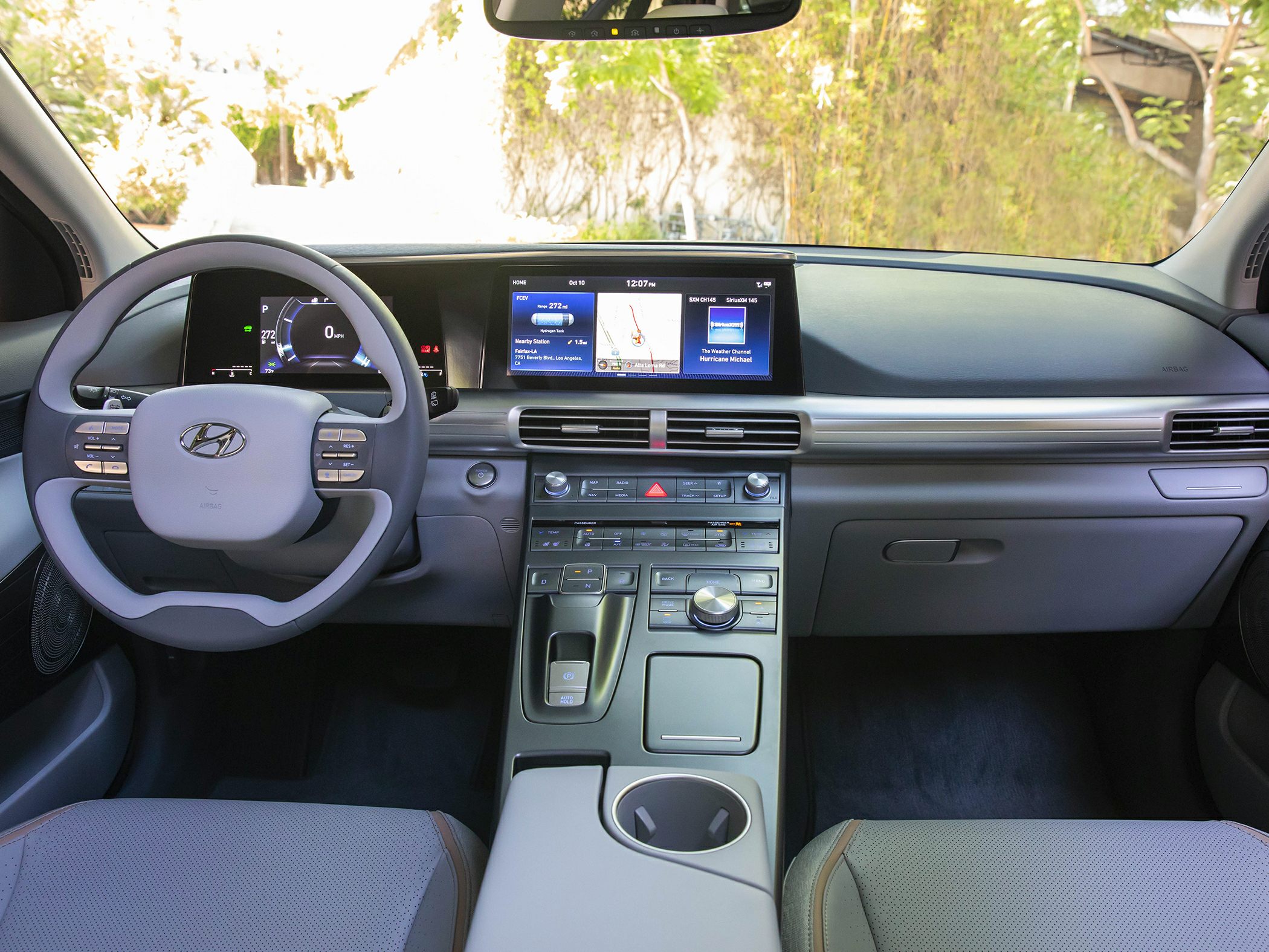Digital dashboard, infotainment screen, steering wheel with controls, center console layout