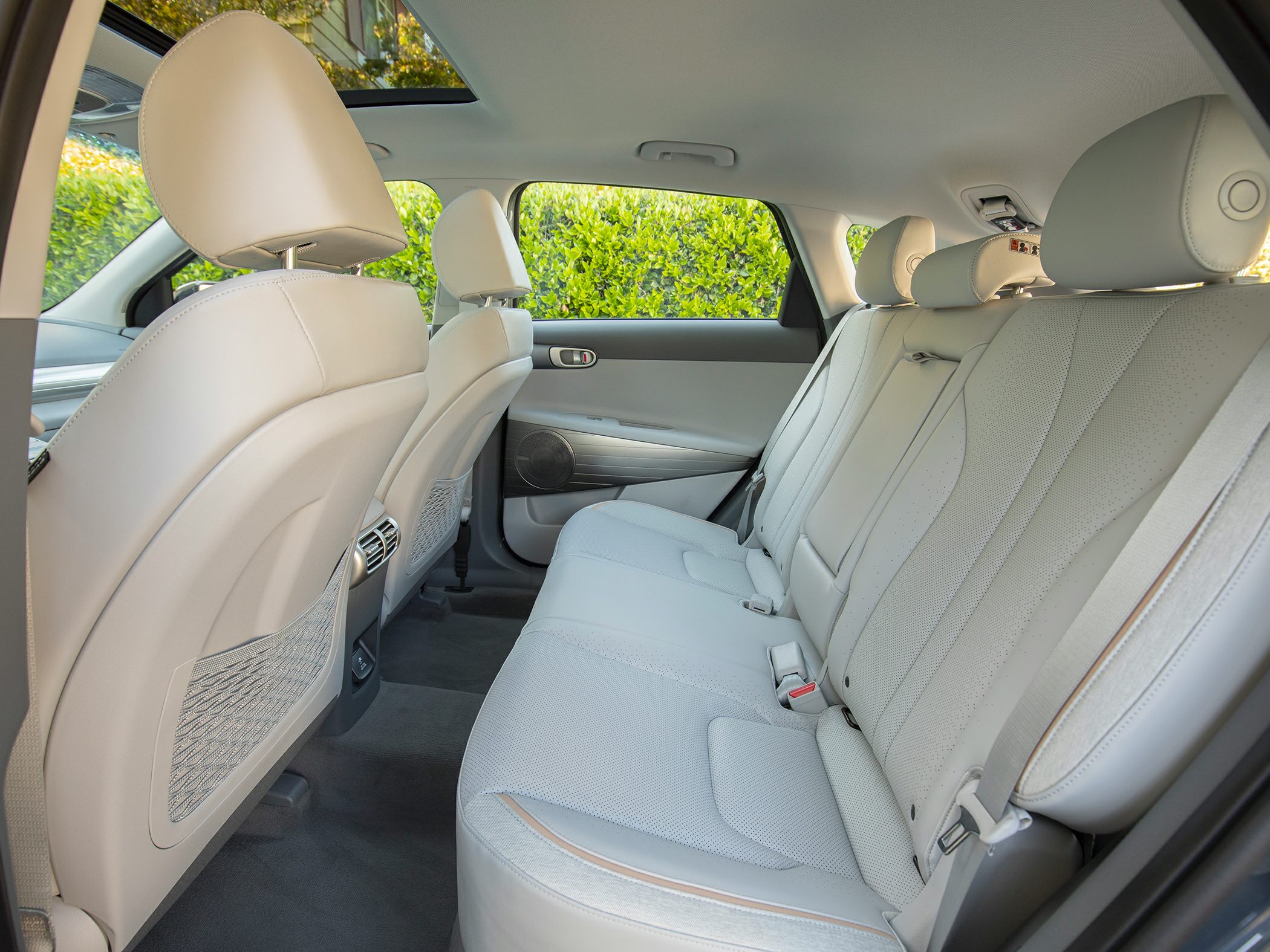 Spacious rear seating with beige leather upholstery and rear air vents