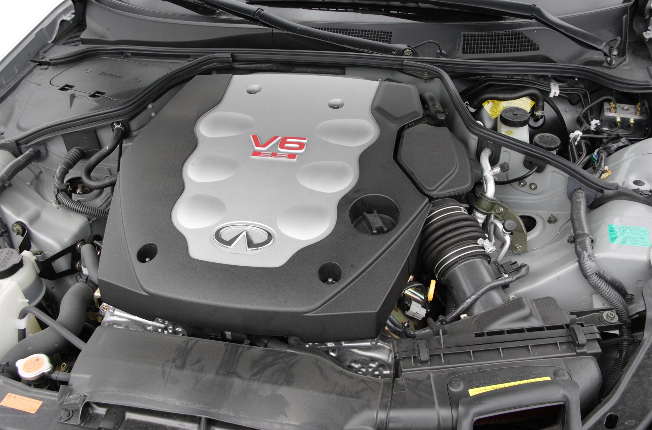 Close-up of a V6 engine with cover and air intake components