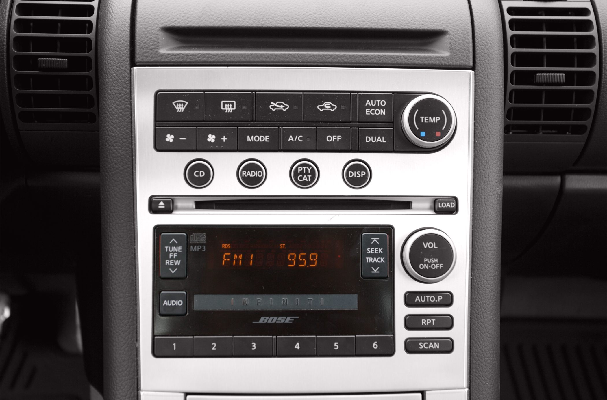 Infiniti car stereo and climate control interface with buttons and dials, showing FM radio display