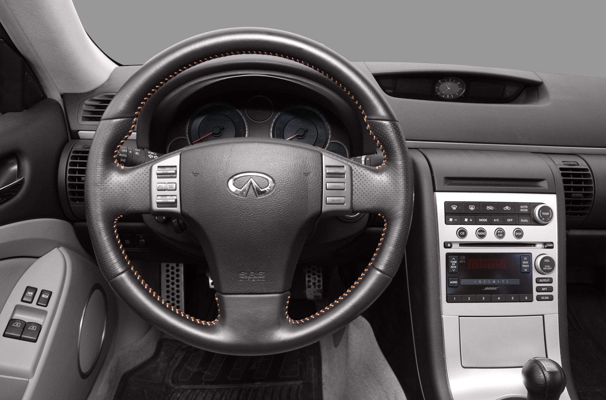 Steering wheel with control buttons and center console with audio and climate controls