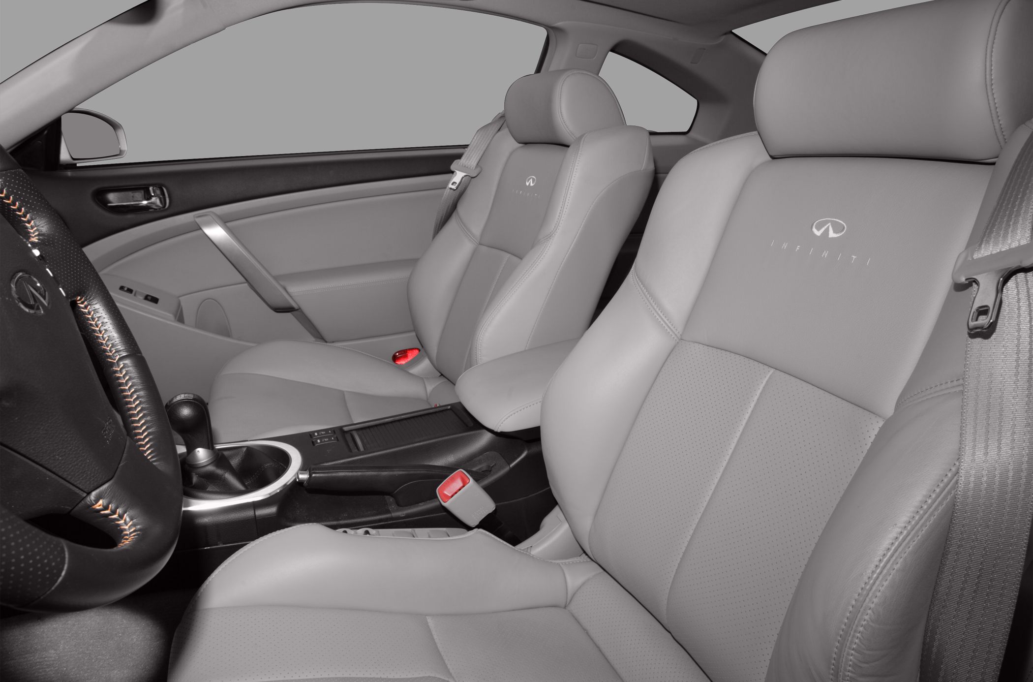 Close-up view of premium leather seats and manual gearshift inside a coupe