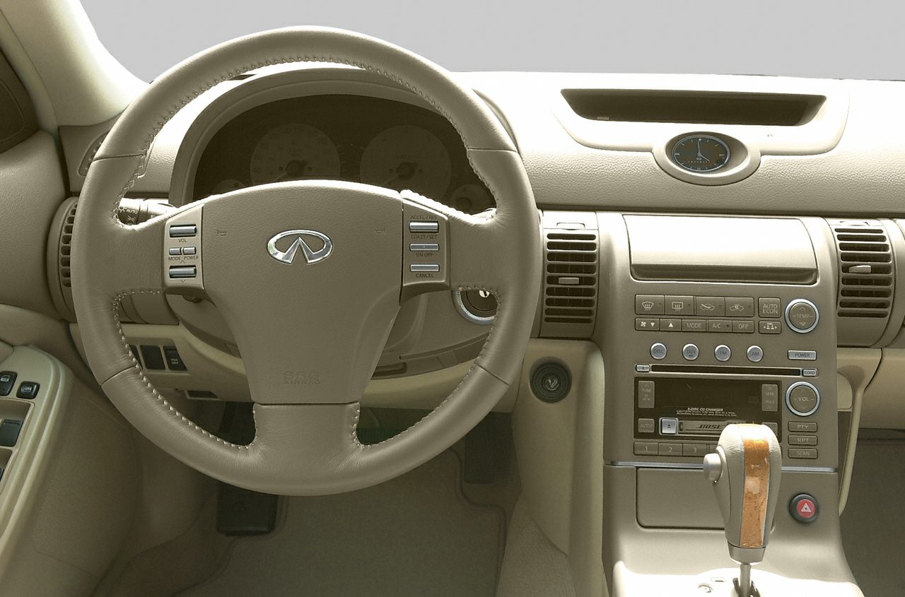 Beige steering wheel and dashboard with wood-trimmed gear shifter