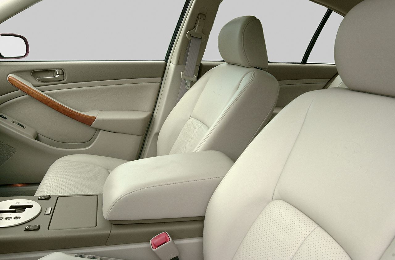 Beige leather seats and wood trim inside front cabin