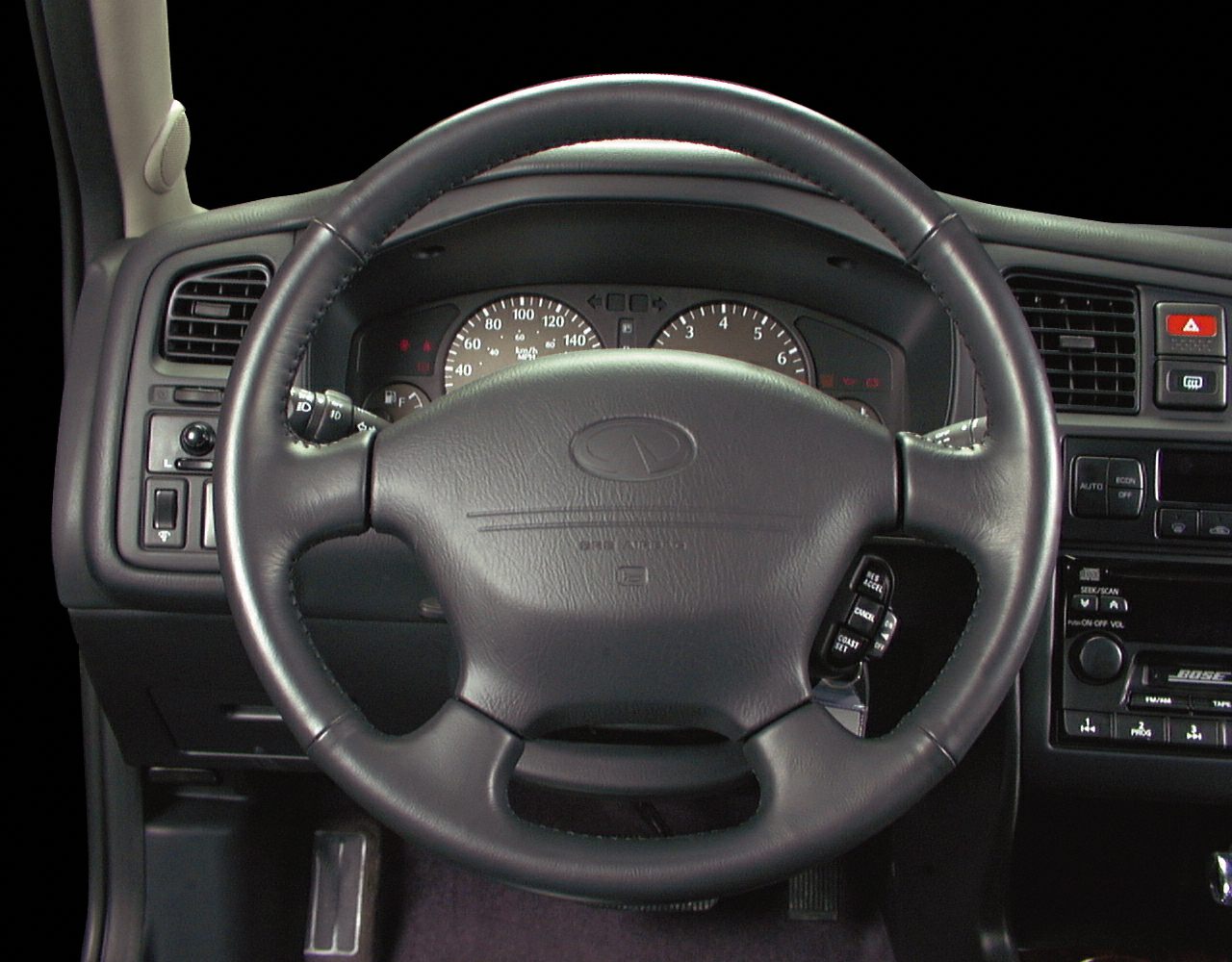 Classic steering wheel and dashboard with controls and gauges.