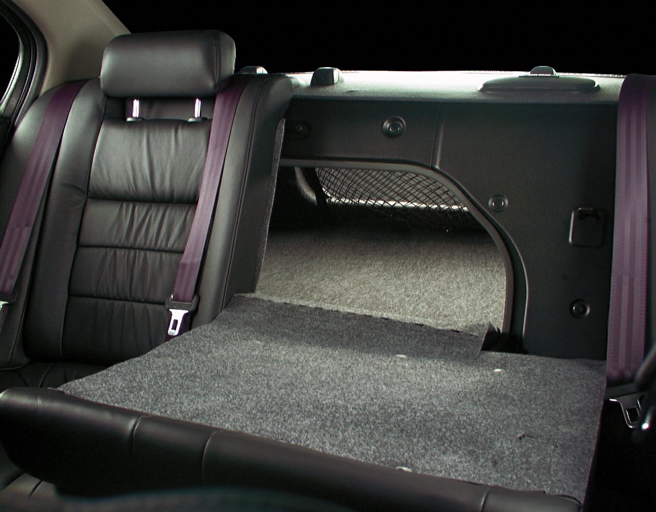 Folded rear seat with cargo pass-through and netted storage in rear interior