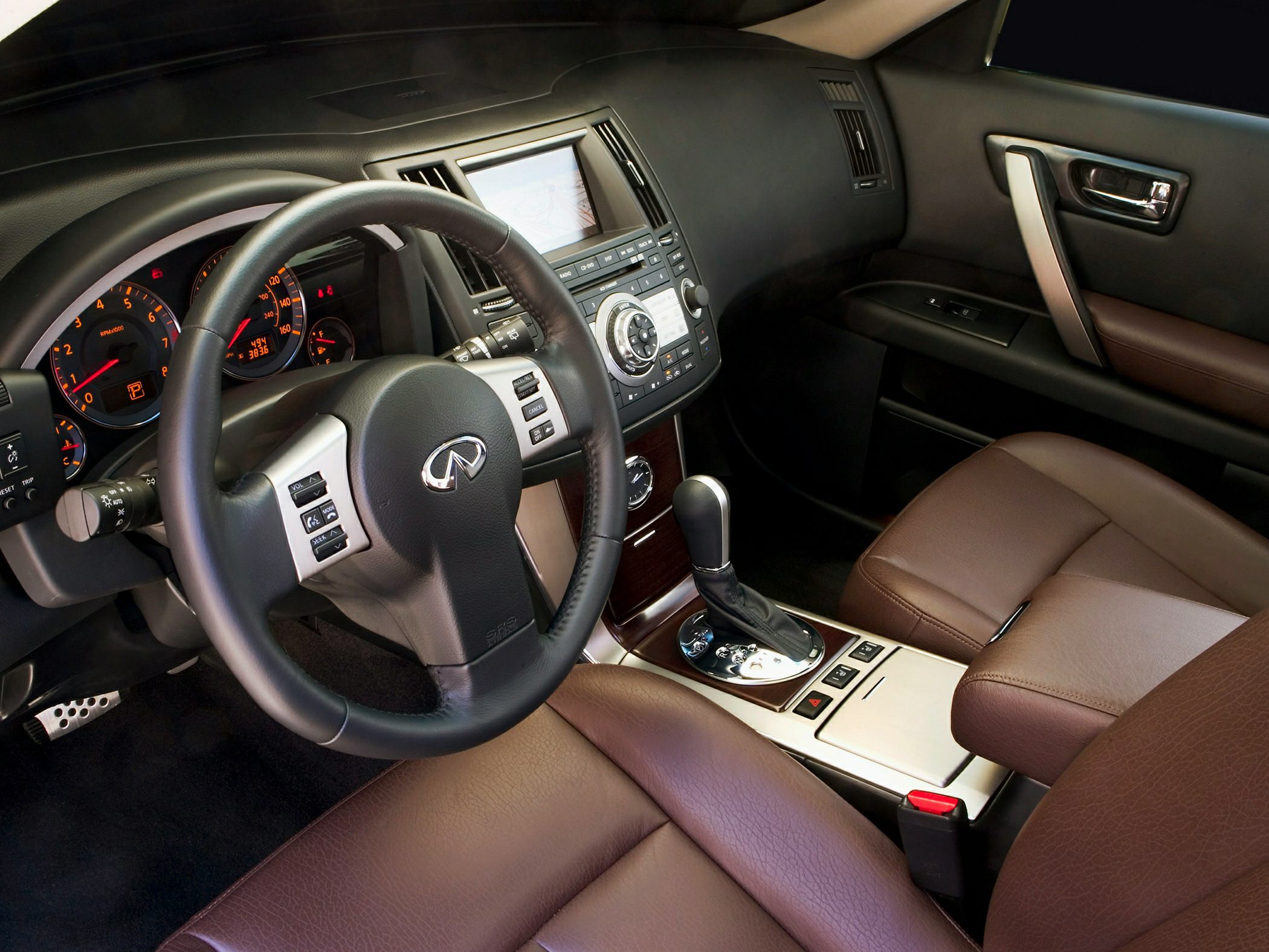 Luxury car interior with dashboard, steering wheel, and leather seats