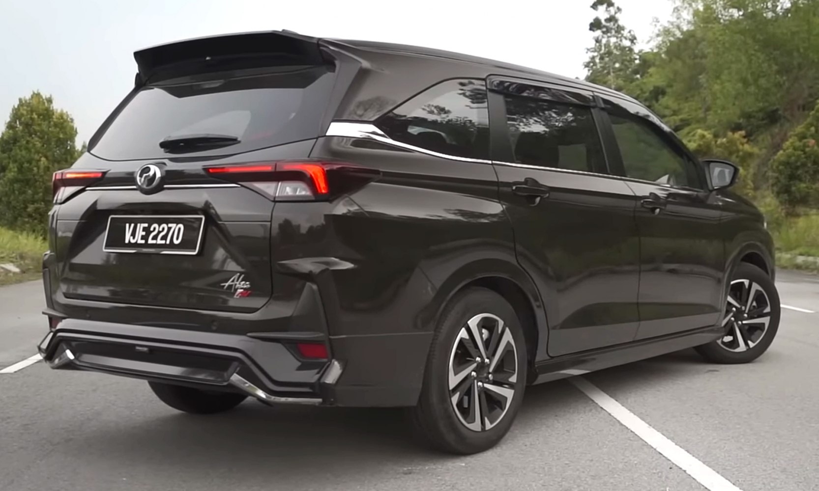 Rear exterior with sporty spoiler, taillights, and alloy wheels