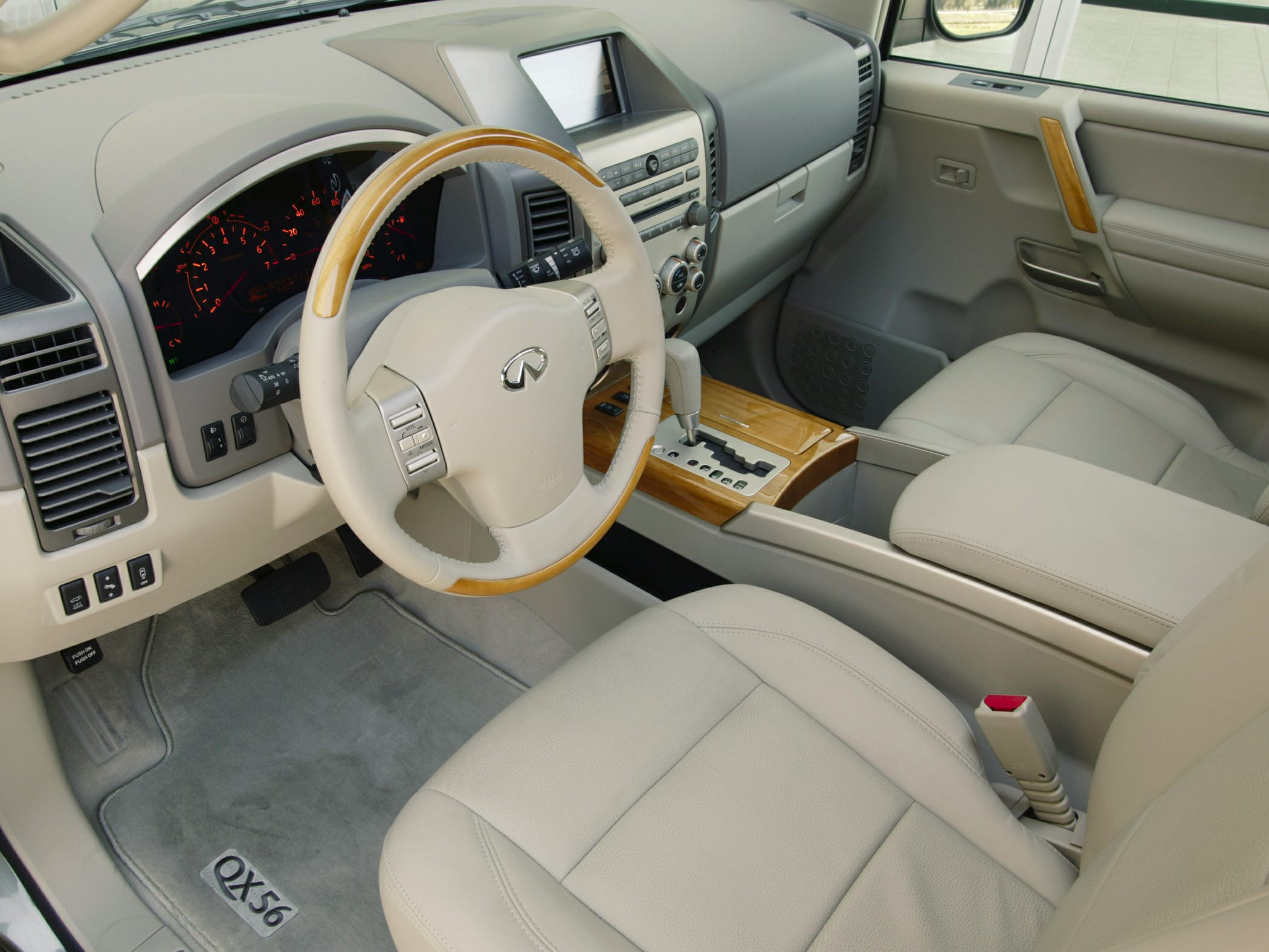 Beige leather interior with wood-trimmed steering wheel and dashboard