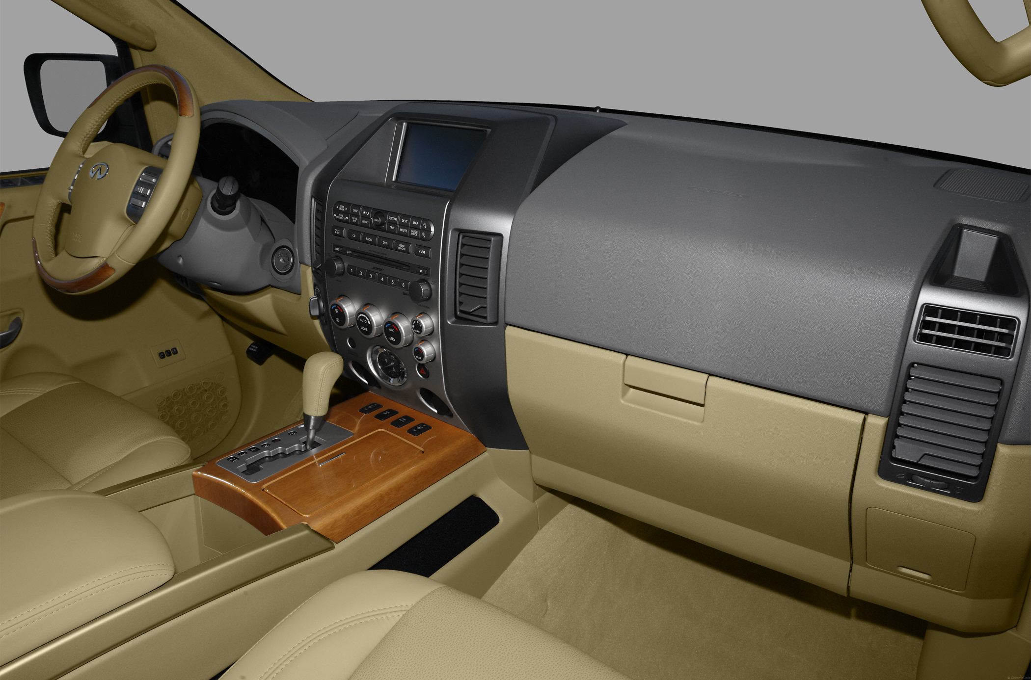 Dashboard, steering wheel, and center console with wood trim and control panels