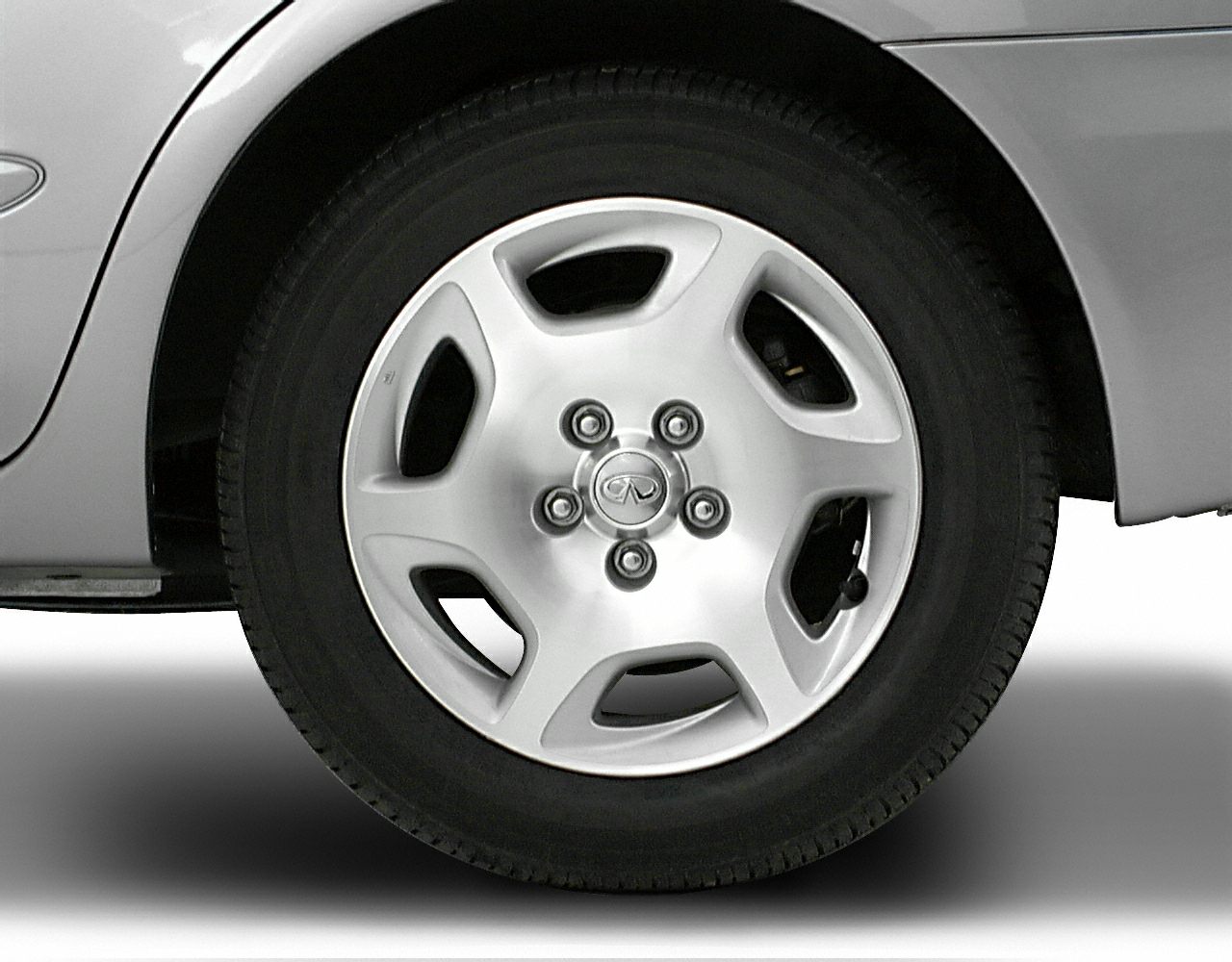 Silver alloy wheel with five spokes and visible lug nuts.