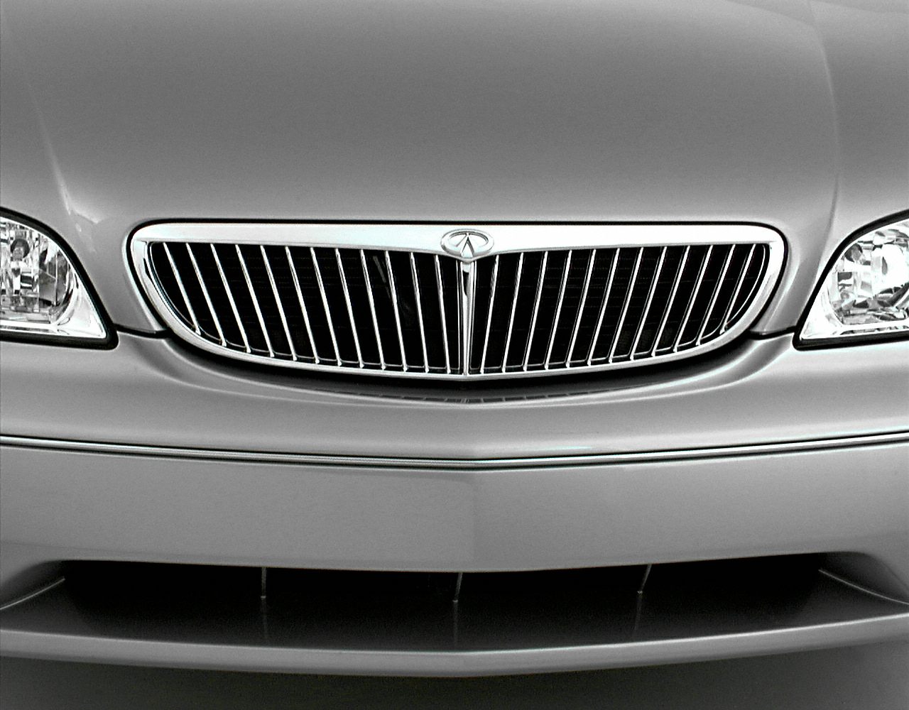 Front grille with vertical slats and flanking headlights