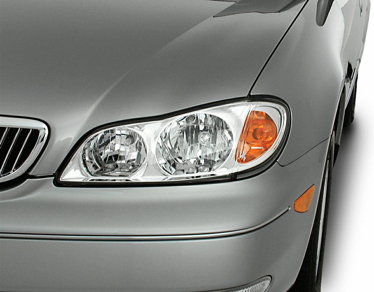 Close-up of car front headlight and grille with turn signal