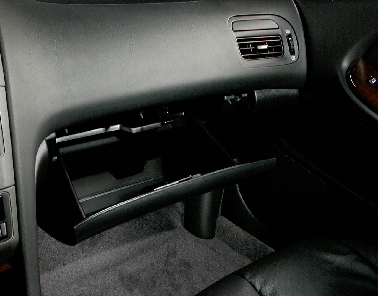 Open glove box and air vent in car interior