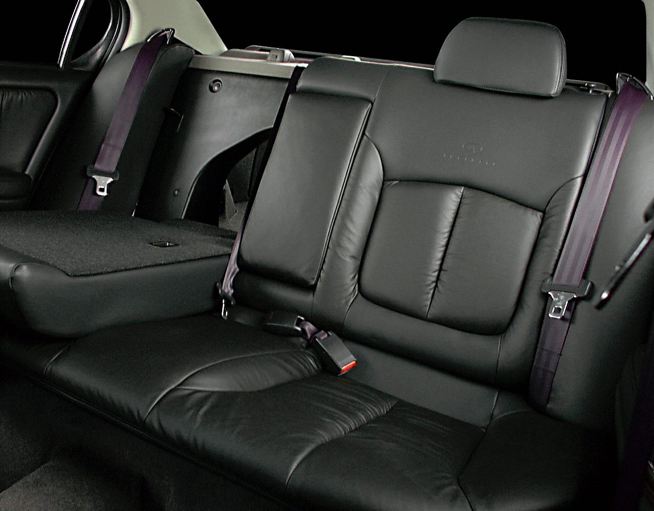 Black leather rear seat with purple seatbelts