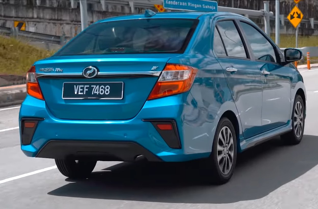 Rear view of blue compact sedan with modern taillights and aerodynamic rear bumper.