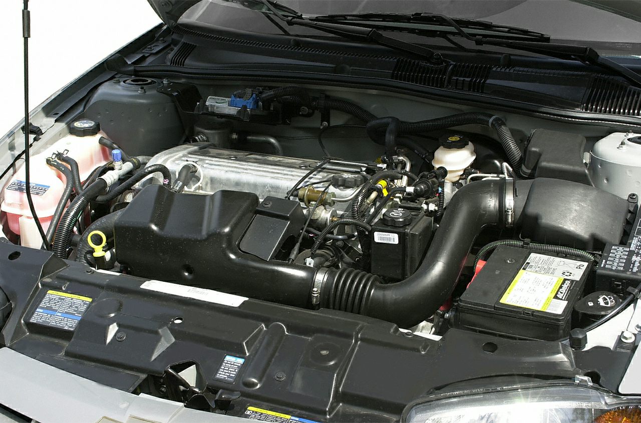 Close-up of engine bay with air intake and battery.