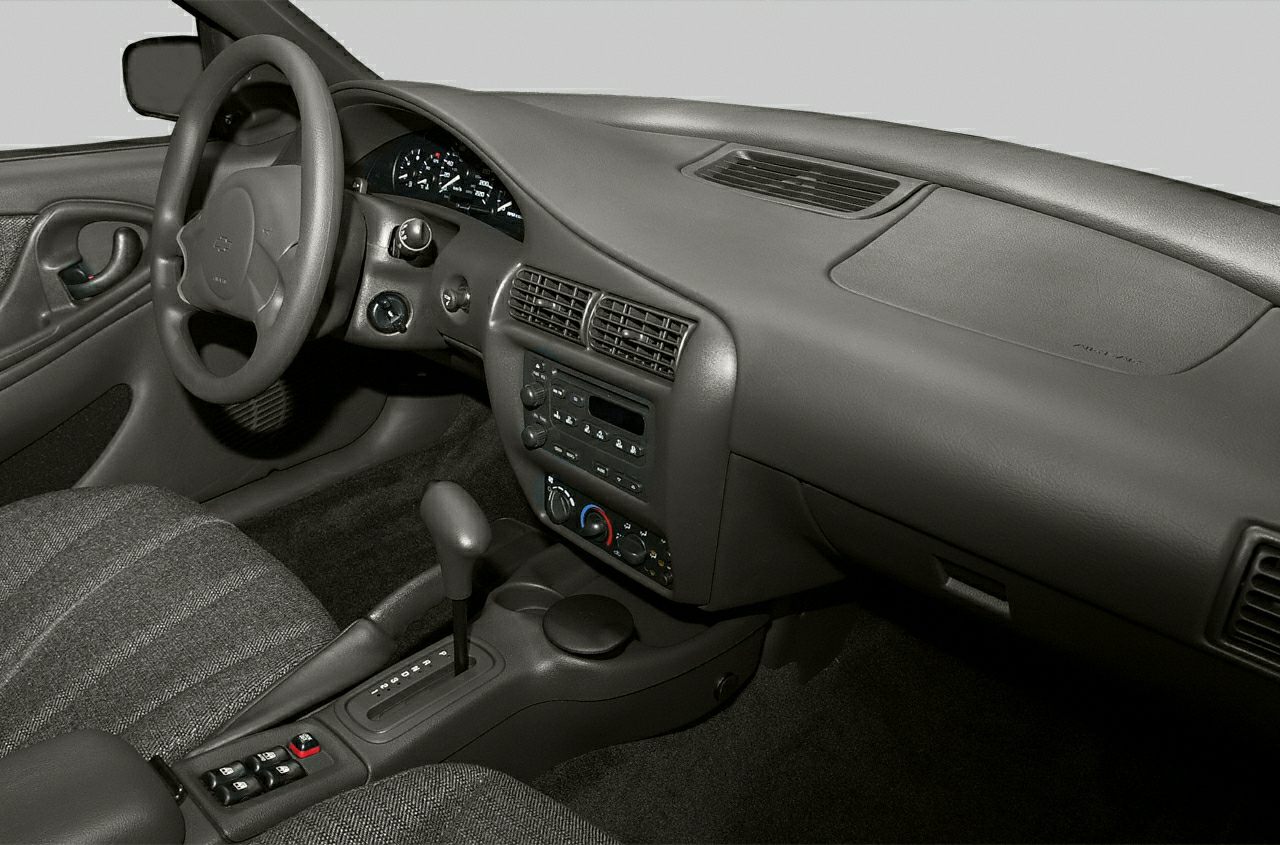 Car interior with dashboard, steering wheel, and automatic gear shift