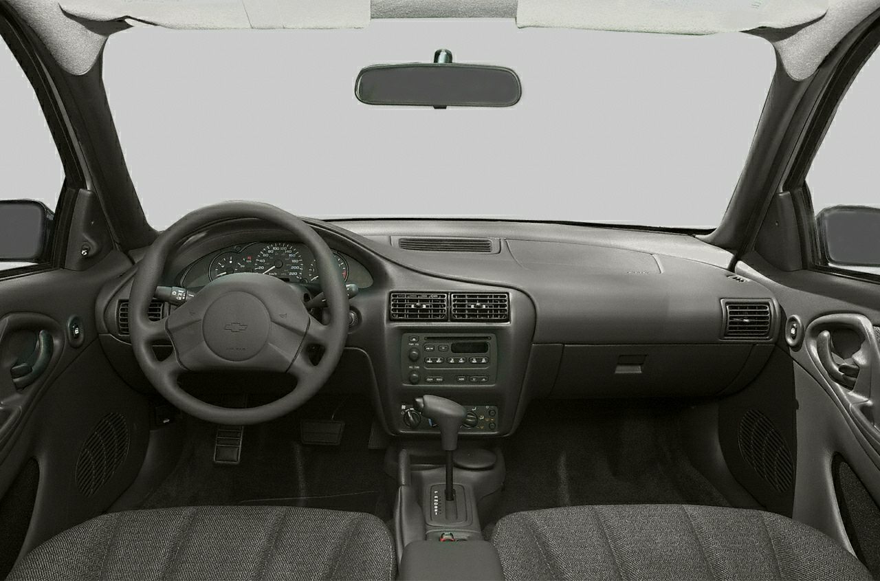 Classic car interior dashboard and steering wheel with center console and automatic gear lever