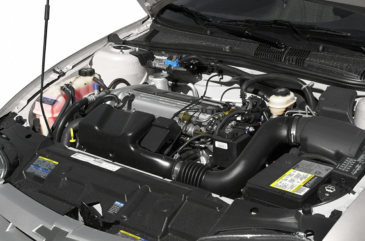 Detailed car engine bay with components and hoses