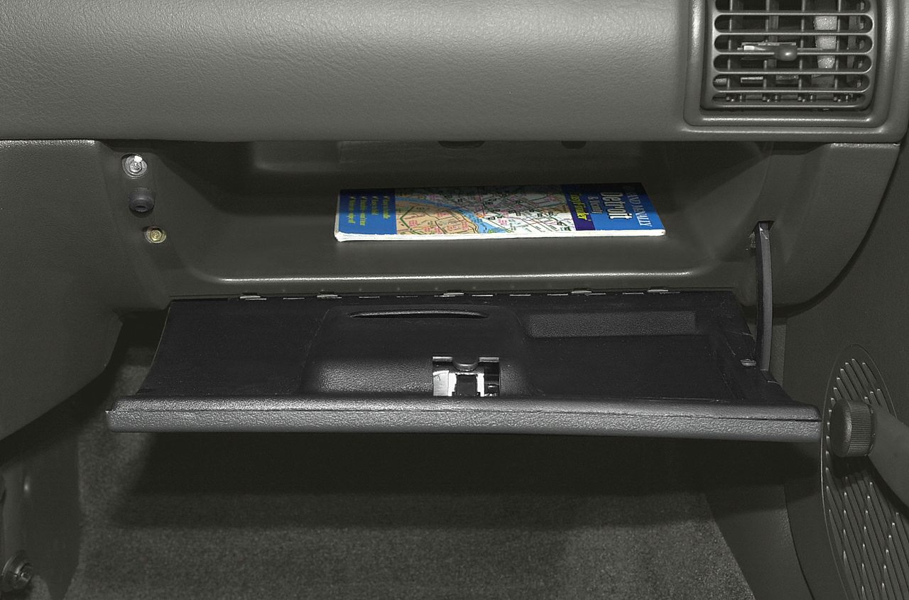 Open glove compartment with map and dashboard vent