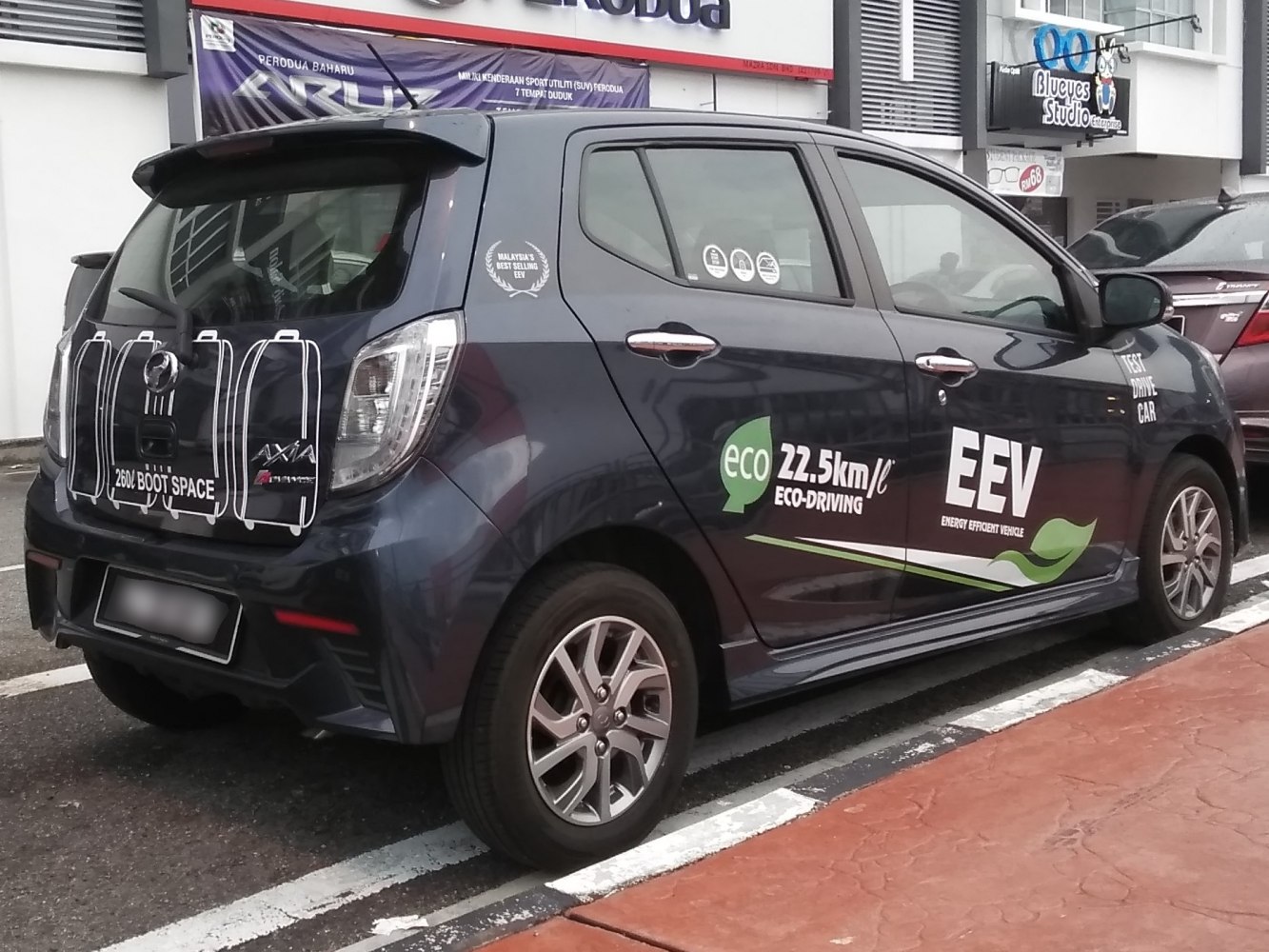 Rear and side view of hatchback with ECO and boot space graphics