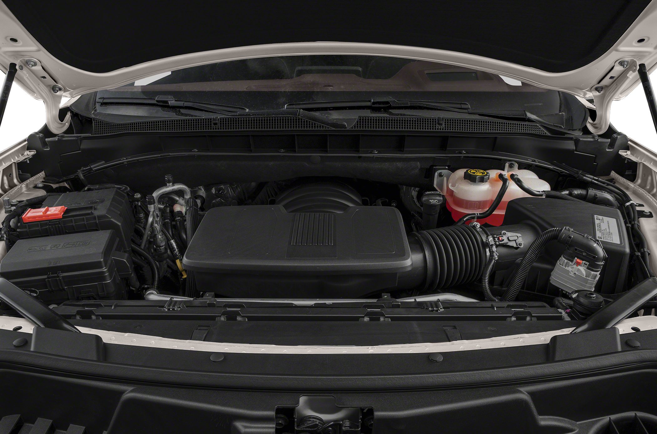 Engine bay with air intake, battery, and coolant reservoir