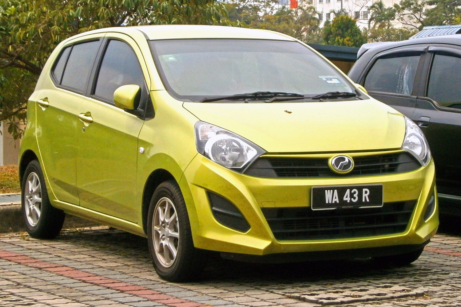 Front view of compact hatchback with distinctive headlights and alloy wheels