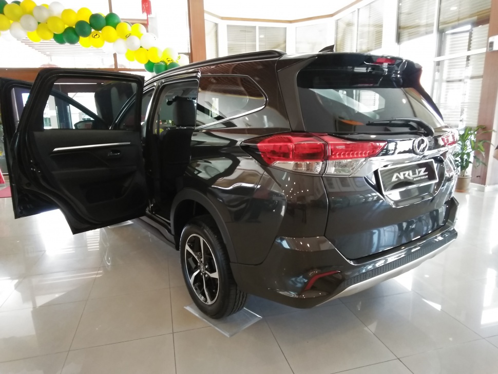 Rear view of SUV with open passenger door and alloy wheel