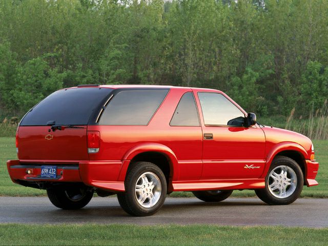 Red 2-door SUV with tinted rear window and alloy wheels.