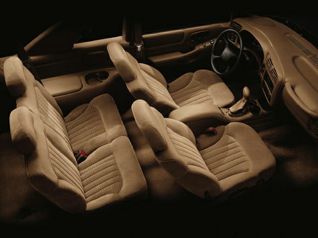 Beige fabric seats interior with manual gear and dashboard layout