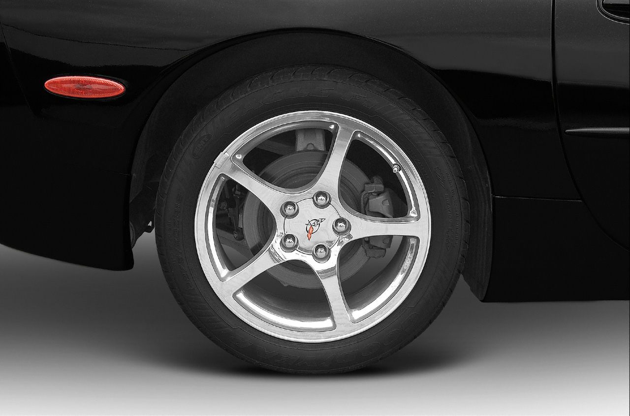 Close-up of alloy wheel and brake caliper on car.