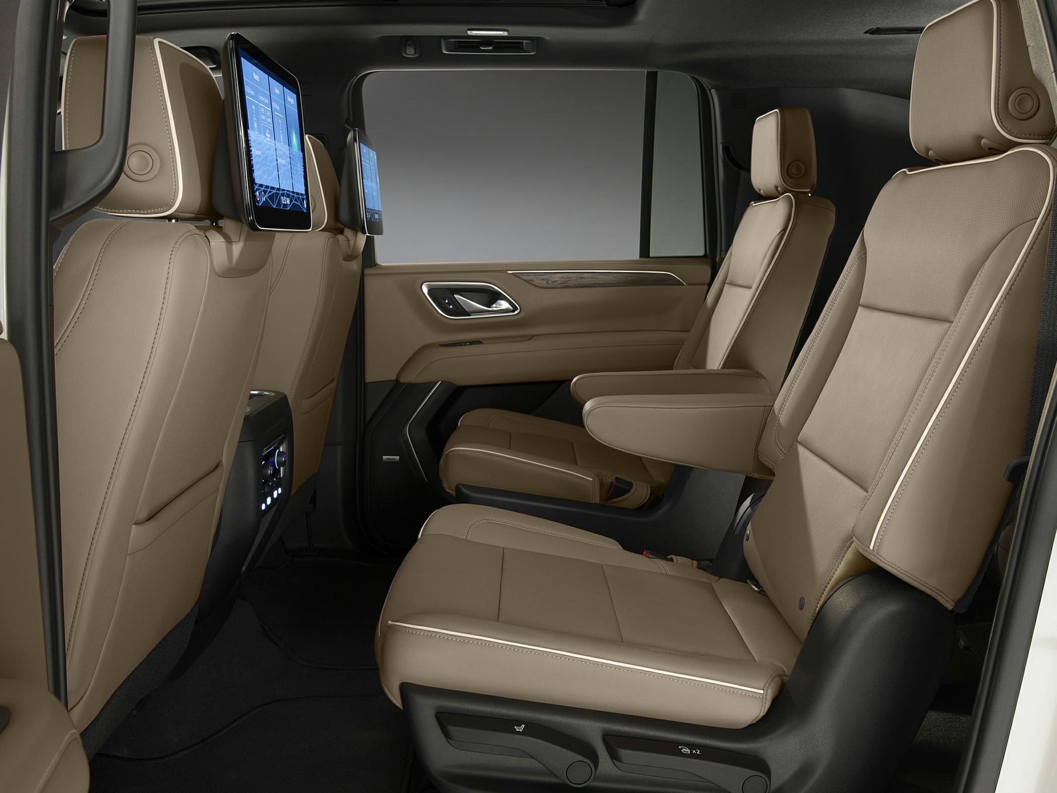 Rear tan leather seats with dual entertainment screens