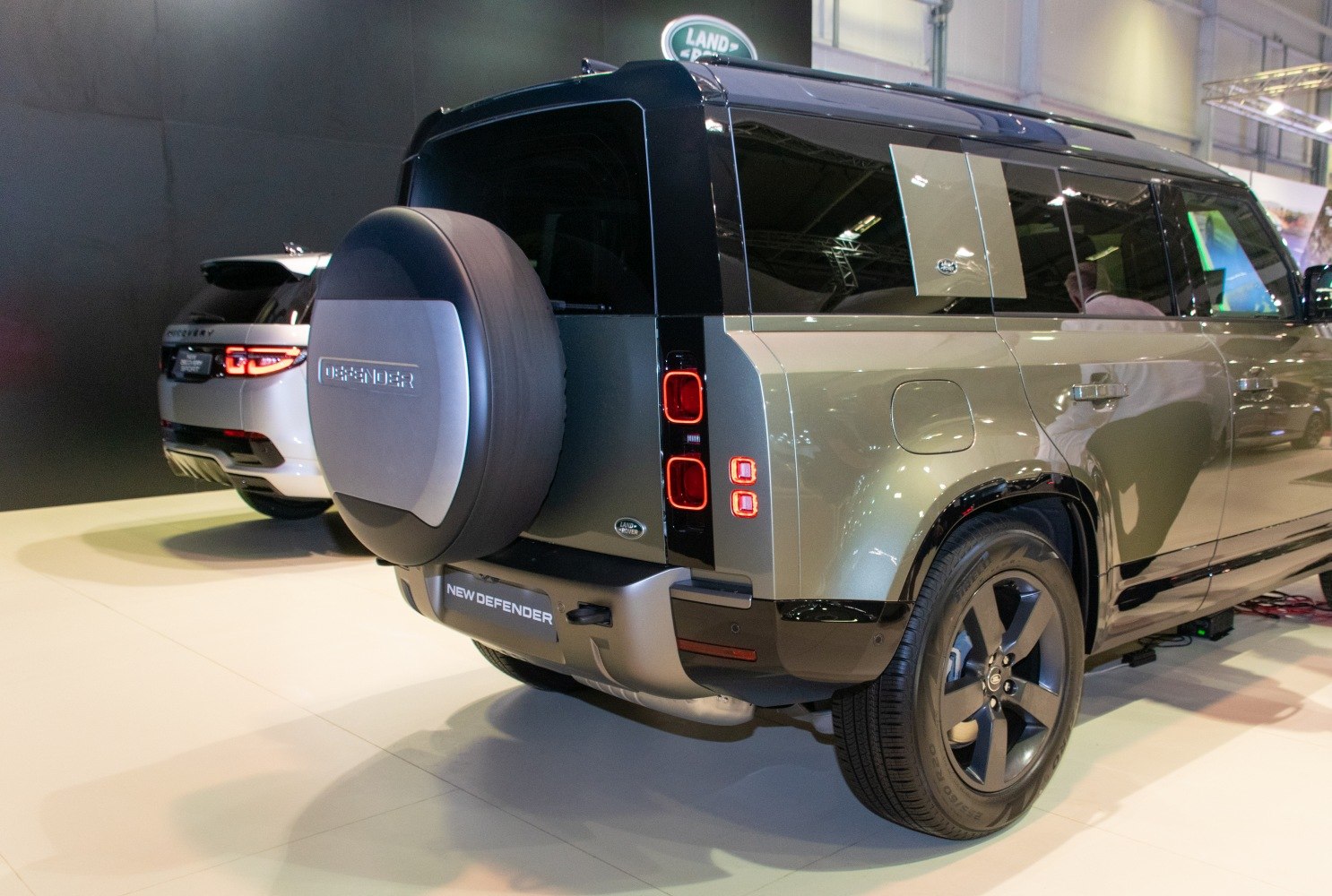Rear view showcasing spare wheel and vertical taillights.