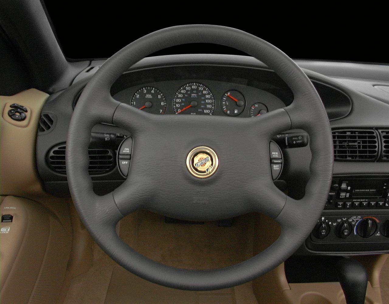 Steering wheel with Chrysler emblem and dashboard instrument cluster