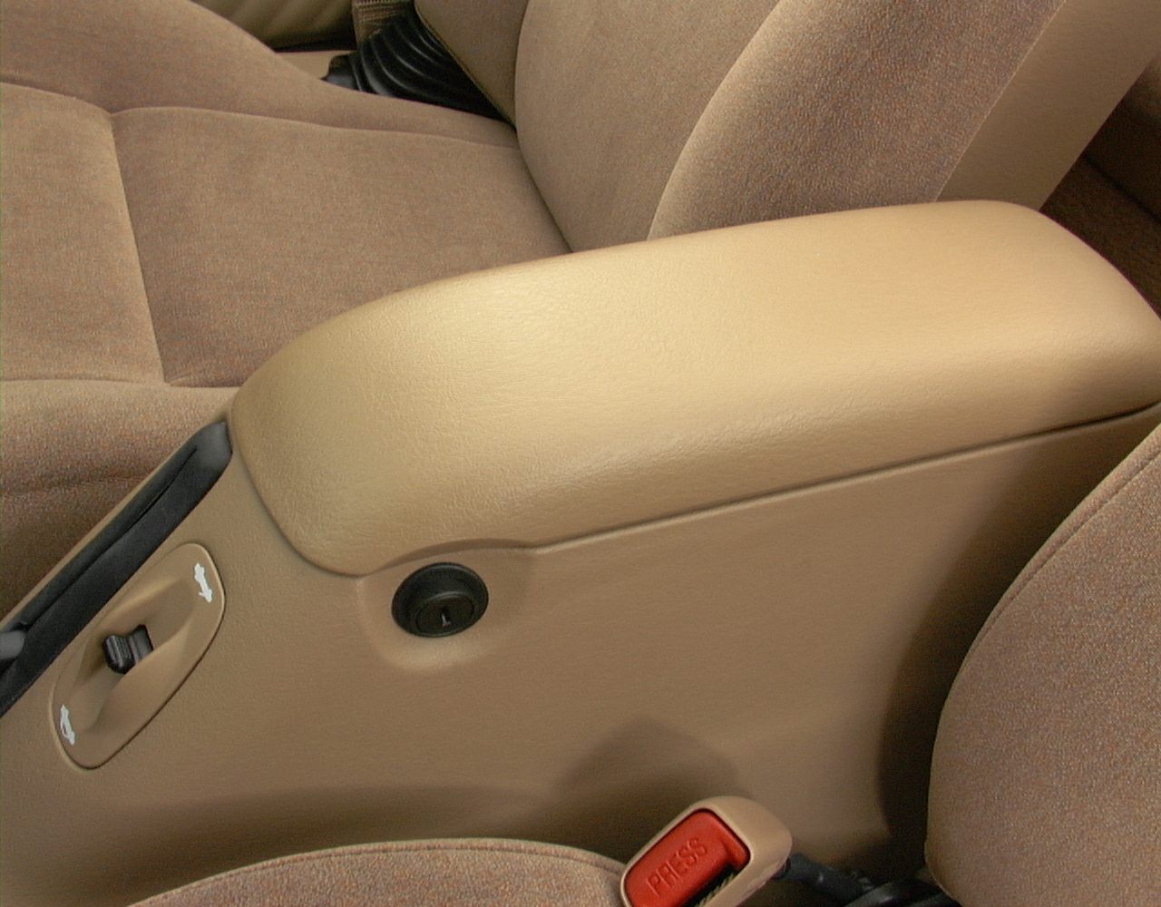 Beige leather center console with brown fabric seats and red seatbelt buckle