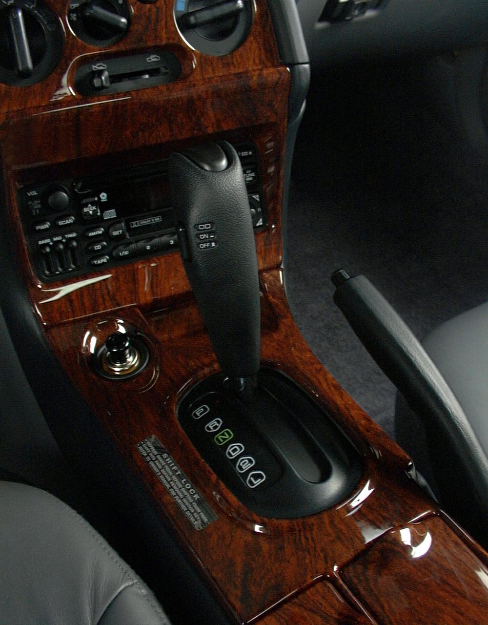 Close-up of gear shift lever and wood-paneled center console