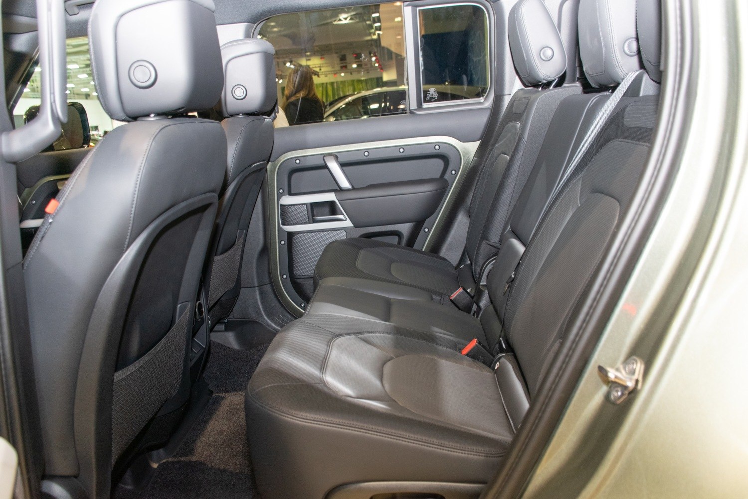 Rear seat interior with black leather upholstery and door panel