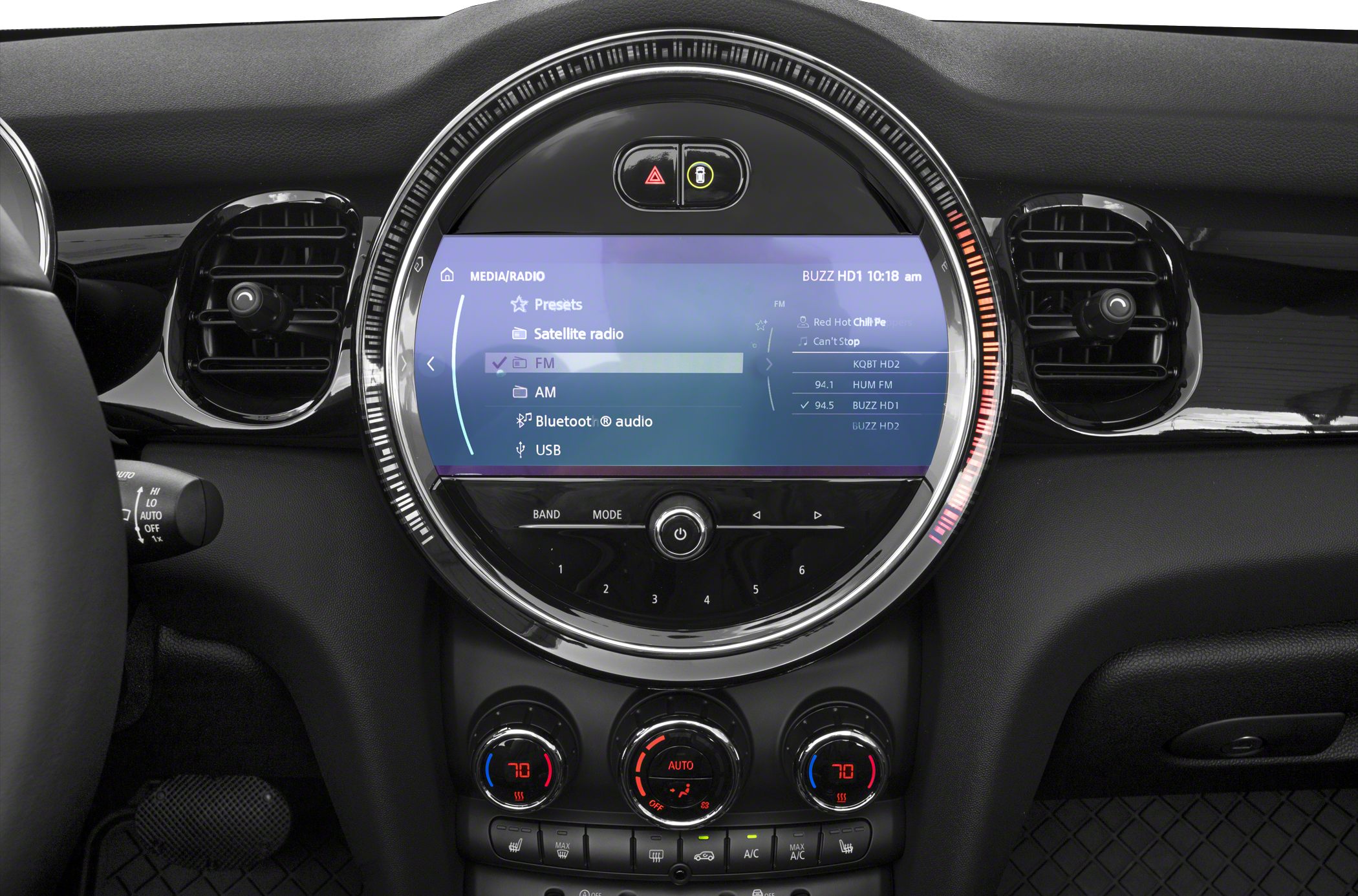 Round infotainment display with media interface and dual-zone climate controls