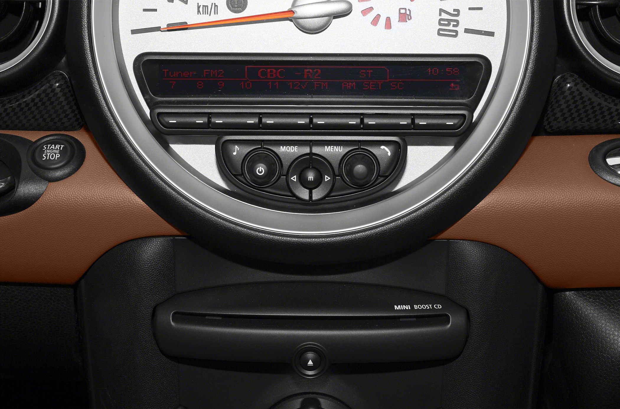 Close-up of speedometer and audio control panel in car dashboard