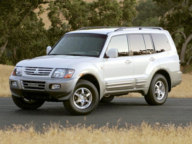 White SUV with roof rails and alloy wheels on a paved road.