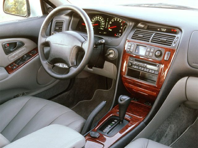 Wood grain center console with analog dashboard and automatic transmission shifter